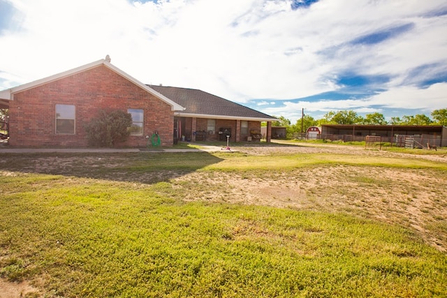 10581 Ballard Rd, San Angelo, TX 76901 - back of property with brick siding and a yard
