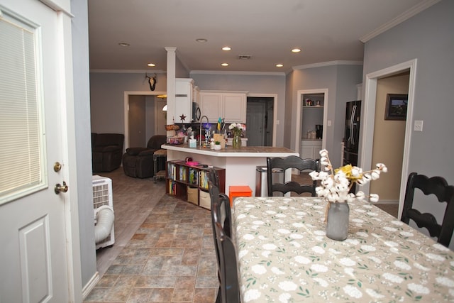 10581 Ballard Rd, San Angelo, TX 76901 - dining room with recessed lighting, crown molding, and light stone finish flooring