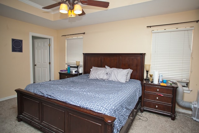 10581 Ballard Rd, San Angelo, TX 76901 - bedroom with light colored carpet, baseboards, a ceiling fan, ornamental molding, and a tray ceiling