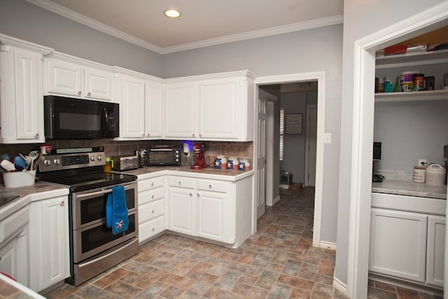 10581 Ballard Rd, San Angelo, TX 76901 - kitchen with black microwave, double oven range, stone finish flooring, tasteful backsplash, and white cabinets