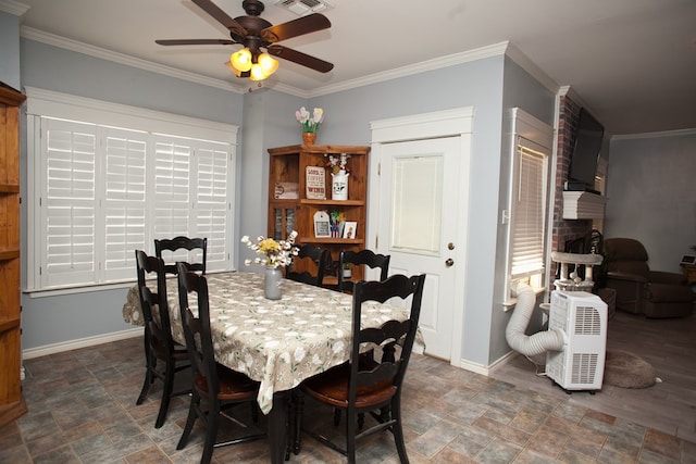 10581 Ballard Rd, San Angelo, TX 76901 - dining area featuring stone finish floors, baseboards, a ceiling fan, and ornamental molding