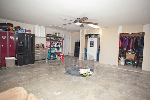 10581 Ballard Rd, San Angelo, TX 76901 - garage featuring black fridge and ceiling fan