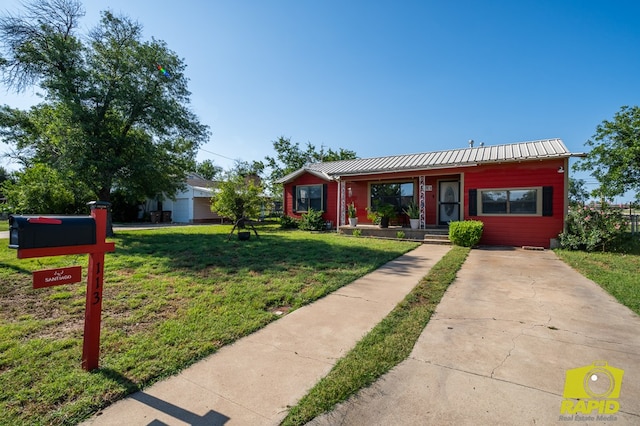 113 N Belaire Ave, San Angelo, TX 76905 - view of front of house featuring metal roof, a front lawn, and concrete driveway