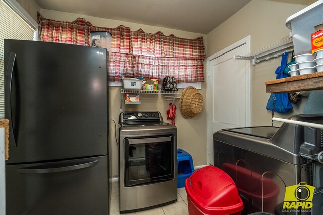 113 N Belaire Ave, San Angelo, TX 76905 - kitchen featuring freestanding refrigerator, washer and dryer, and tile patterned flooring