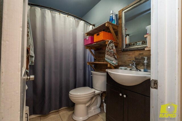 113 N Belaire Ave, San Angelo, TX 76905 - full bathroom with tile patterned floors, vanity, toilet, and a shower with curtain