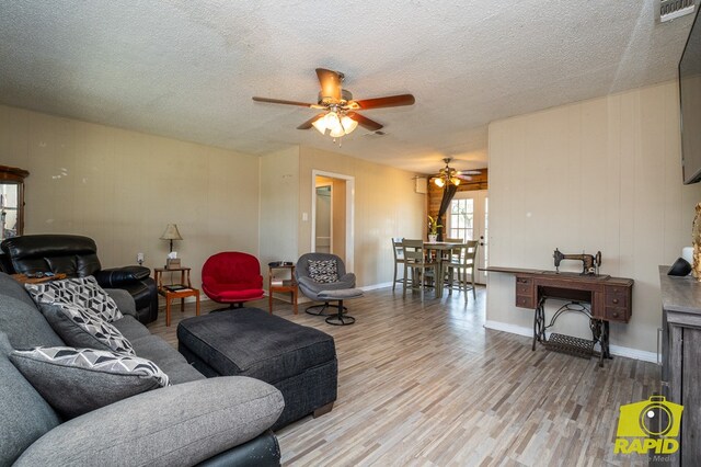 113 N Belaire Ave, San Angelo, TX 76905 - living area with a ceiling fan, wood finished floors, a textured ceiling, and baseboards