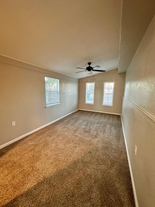 unfurnished room with lofted ceiling, carpet floors, and ceiling fan