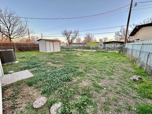 view of yard featuring cooling unit and a storage unit