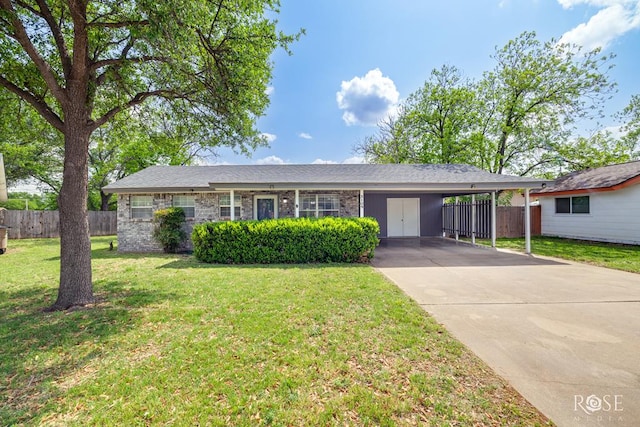 ranch-style house featuring fence, a front lawn, an attached carport, and concrete driveway