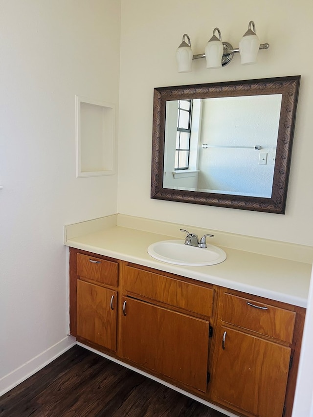 1723 Utah Ave, San Angelo, TX 76904 - bathroom with vanity, wood finished floors, and baseboards