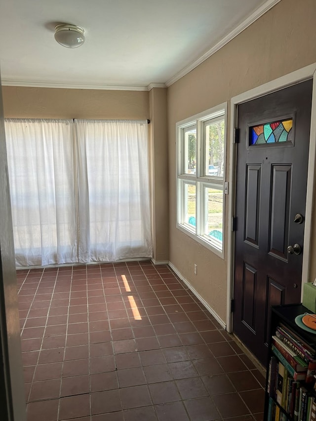 tiled foyer featuring ornamental molding