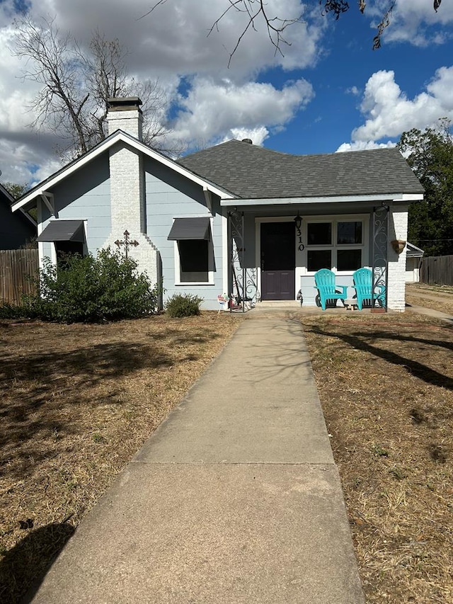 view of front of home with a porch and a front yard