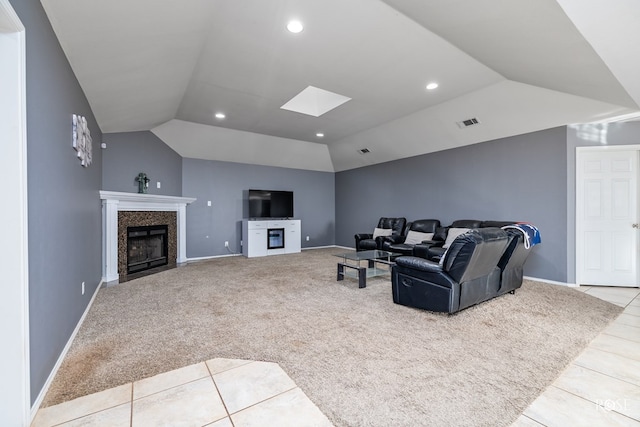 living room with light colored carpet and vaulted ceiling with skylight