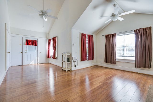 foyer entrance with high vaulted ceiling, wood finished floors, a ceiling fan, and baseboards