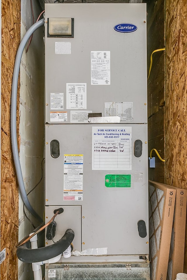 utility room featuring heating unit