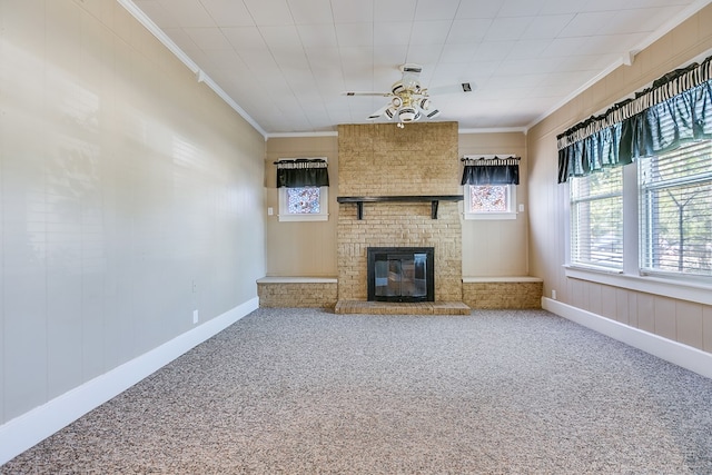 unfurnished living room featuring carpet, ceiling fan, a brick fireplace, and crown molding