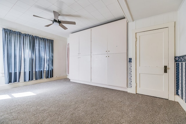 unfurnished bedroom featuring a closet, carpet, and a ceiling fan