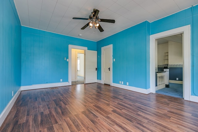 unfurnished bedroom with a ceiling fan, wood finished floors, visible vents, and baseboards