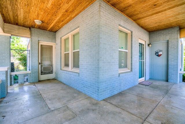 entrance to property with brick siding and cooling unit