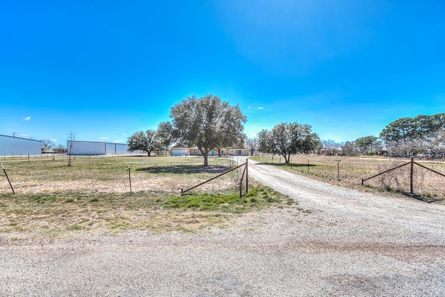 view of street with a rural view and driveway