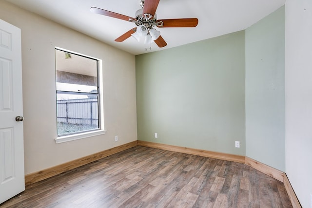 empty room featuring wood finished floors and baseboards