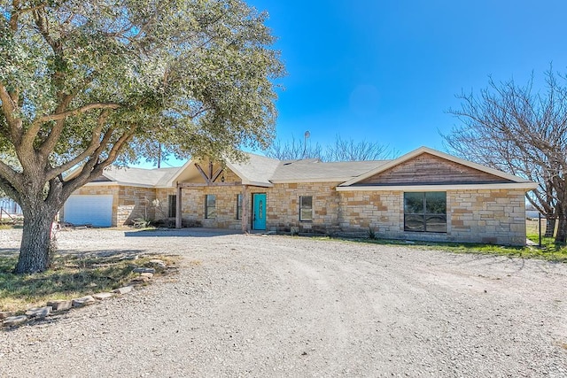 single story home with driveway and an attached garage