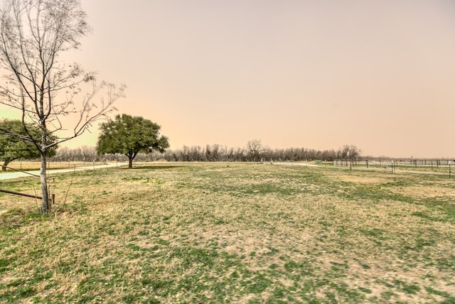 view of yard featuring a rural view and fence