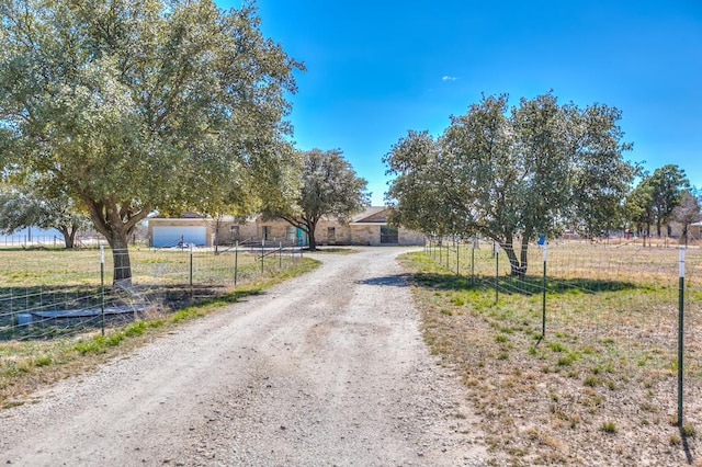 view of road featuring dirt driveway