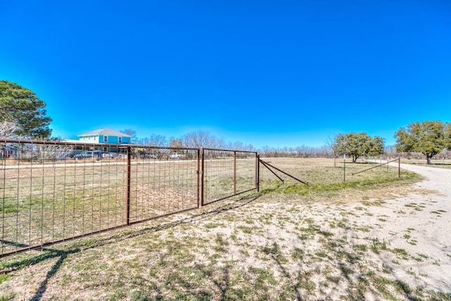 view of yard featuring a rural view and fence