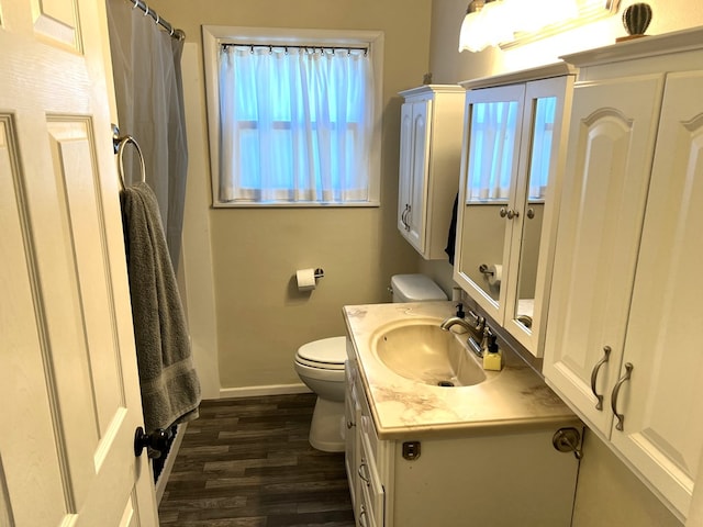 bathroom featuring vanity, toilet, and wood-type flooring