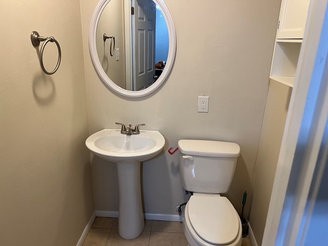 bathroom featuring tile patterned flooring, sink, and toilet