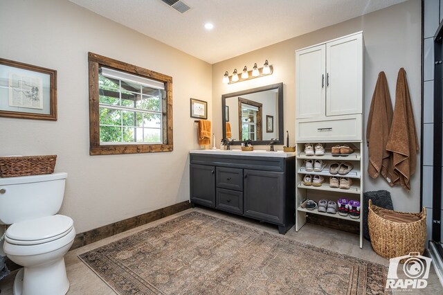 715 E Main St, Bronte, TX 76933 - bathroom with vanity, toilet, and baseboards