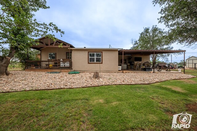 715 E Main St, Bronte, TX 76933 - rear view of property featuring stucco siding, a yard, a patio, and a deck