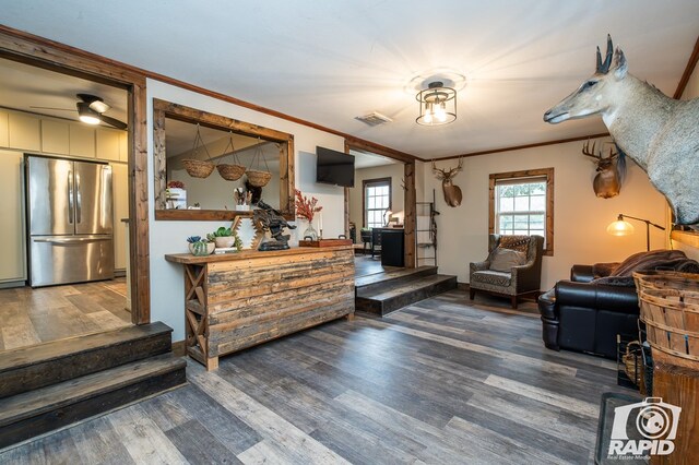 715 E Main St, Bronte, TX 76933 - sitting room with wood finished floors, ornamental molding, ceiling fan, and baseboards