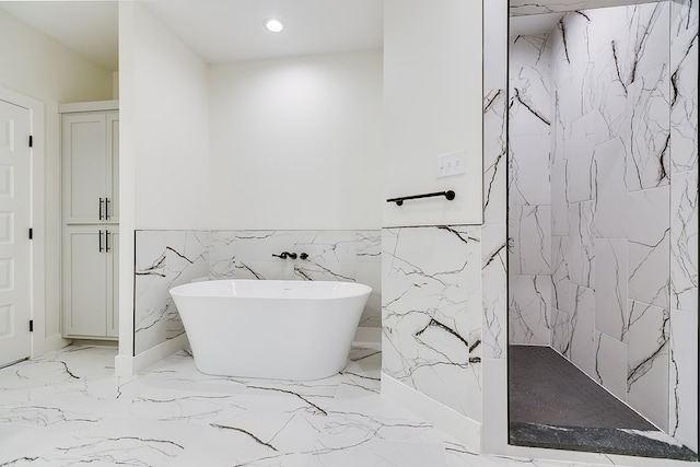 bathroom featuring shower with separate bathtub