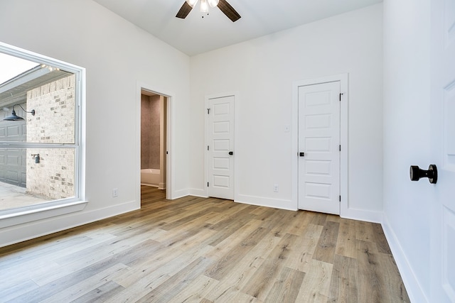 unfurnished bedroom with ceiling fan and light hardwood / wood-style flooring