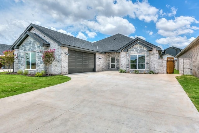 view of front of house with a garage and a front lawn