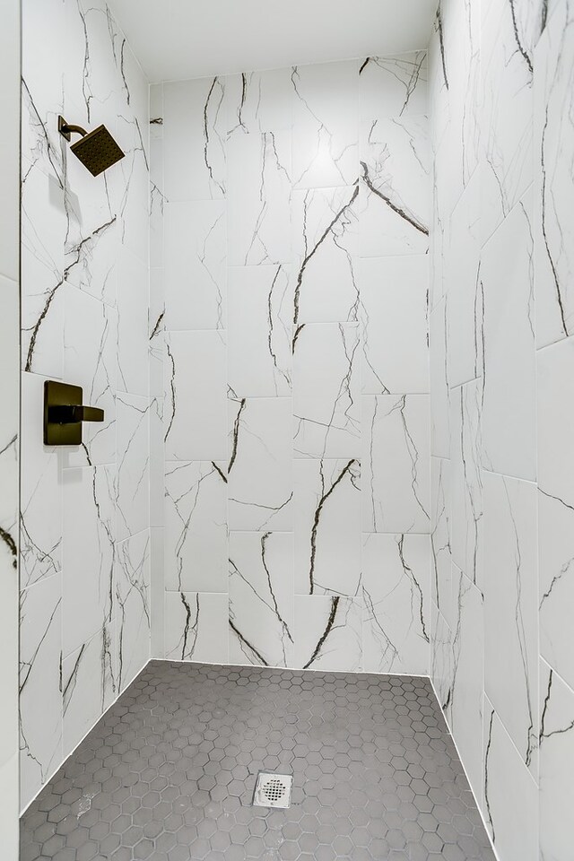 interior space featuring tile patterned floors and tiled shower