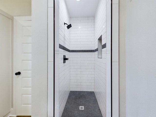 bathroom with tiled shower