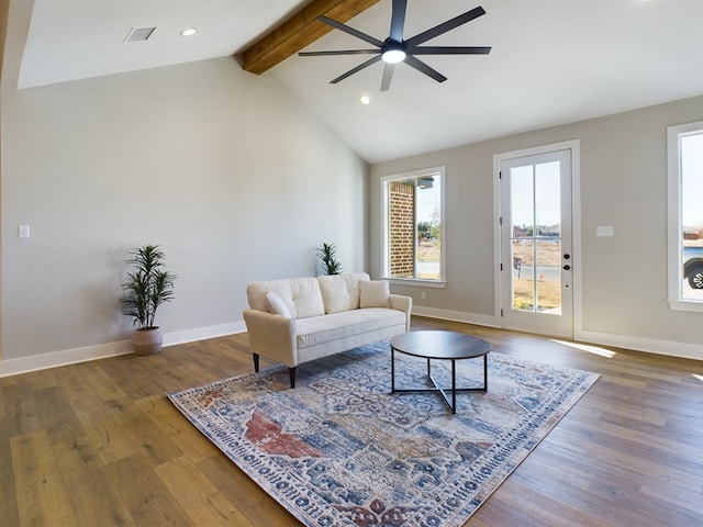 living room with dark wood-type flooring, ceiling fan, and vaulted ceiling with beams