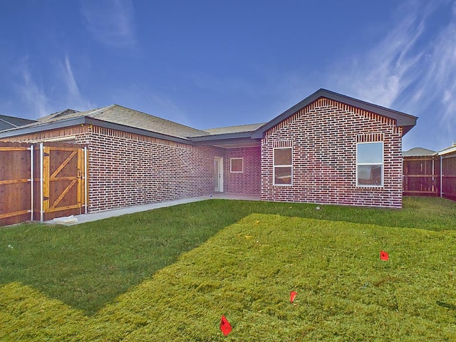 rear view of property with a yard