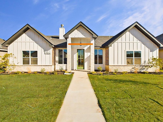 modern inspired farmhouse with a front yard