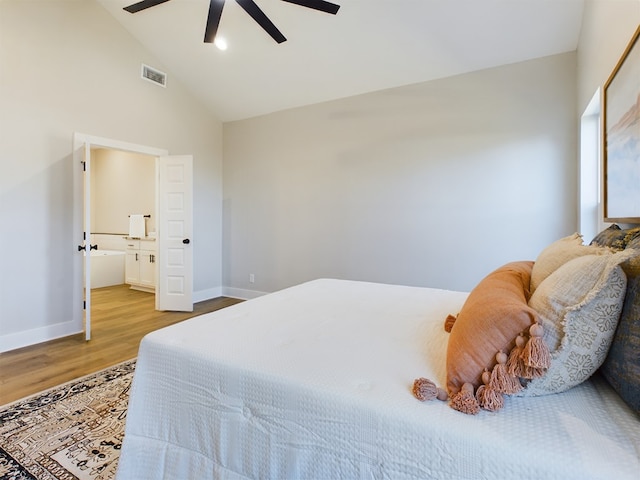 bedroom featuring lofted ceiling, wood-type flooring, ceiling fan, and ensuite bathroom