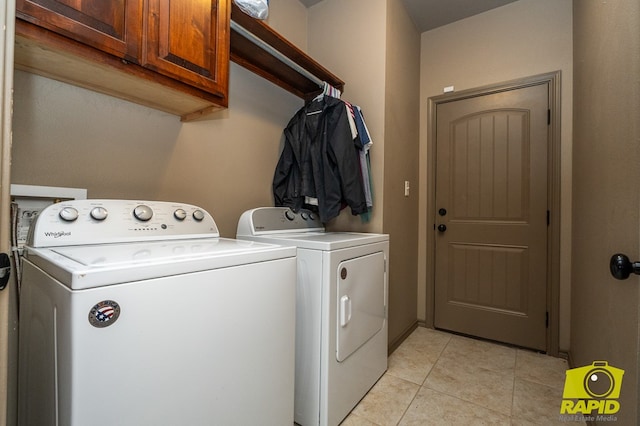 3286 Ponca Path, San Angelo, TX 76901 - laundry area featuring cabinet space, washer and dryer, and light tile patterned floors