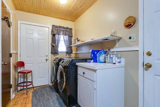 laundry room with washing machine and dryer, wooden ceiling, and light hardwood / wood-style floors