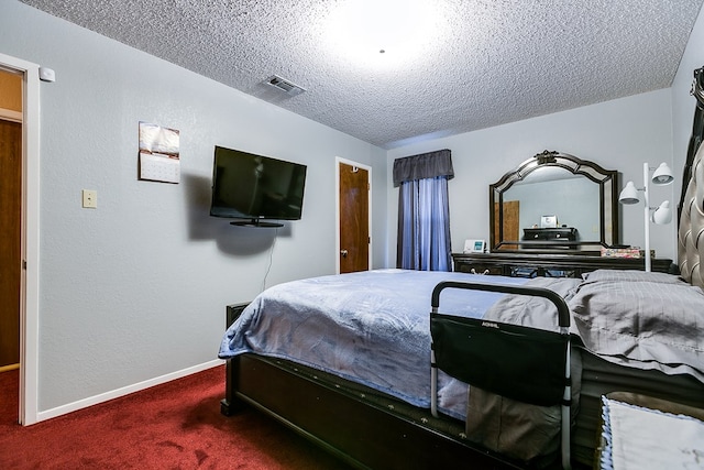 carpeted bedroom featuring a textured ceiling