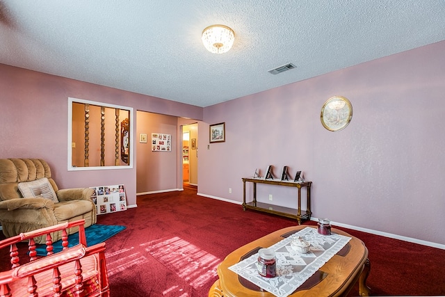 living area with carpet flooring and a textured ceiling