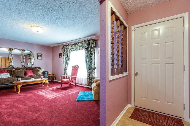 sitting room featuring carpet floors and a textured ceiling