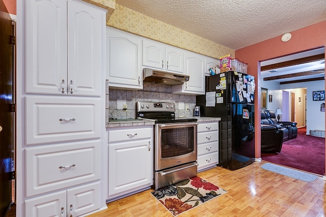 kitchen with electric stove, white cabinetry, black fridge, a textured ceiling, and light hardwood / wood-style flooring