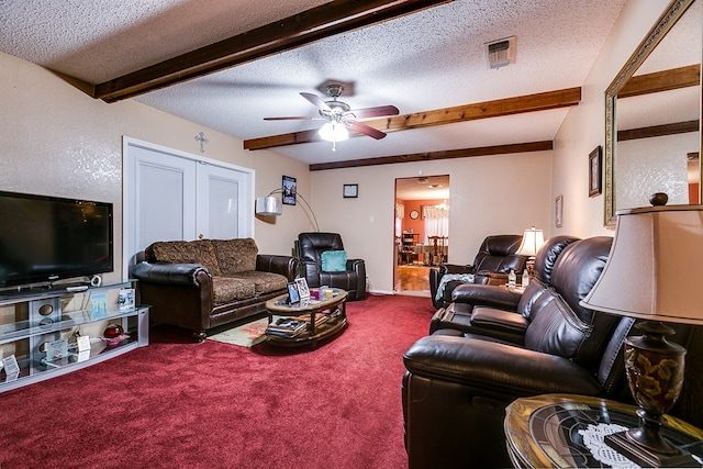 carpeted living room featuring beamed ceiling, ceiling fan, and a textured ceiling